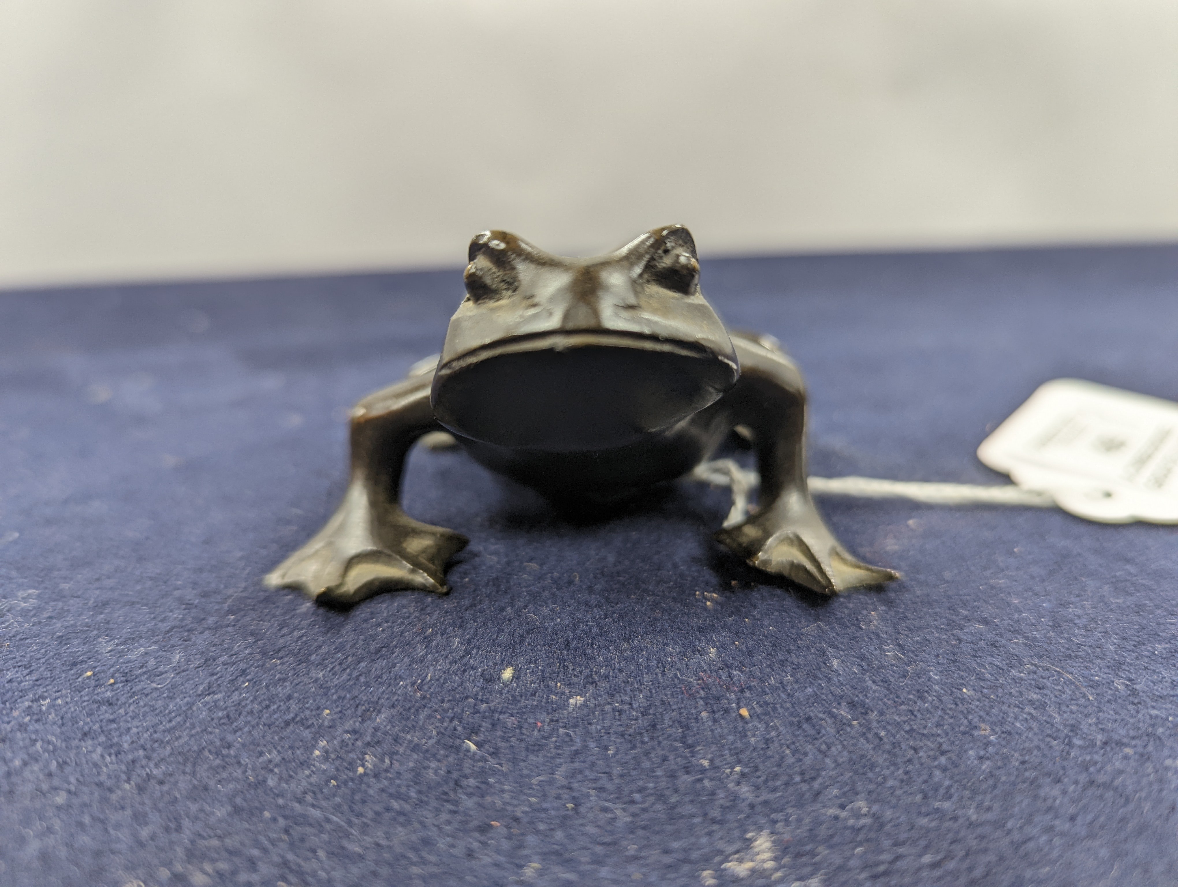 A Chinese bronze group of Liu Hai and a toad, wood stand and a bronze figure of a dog, 9cm